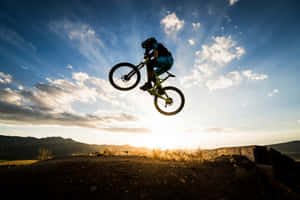 Mountain Biker Sunset Jump Wallpaper