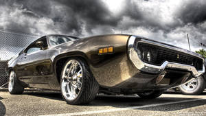 Muscle Car Under Gray Clouds Wallpaper