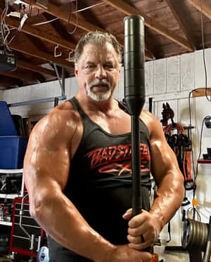 Muscled Manin Gym Holding Weighted Bar Wallpaper