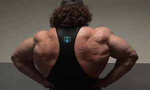 Muscular Back Pose Fitness Enthusiast Wallpaper