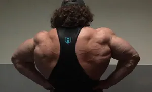 Muscular Back Pose Fitness Enthusiast Wallpaper
