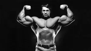 Muscular Man Double Biceps Pose Wallpaper