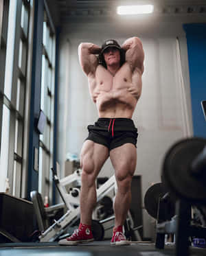 Muscular Man Posingin Gym Wallpaper