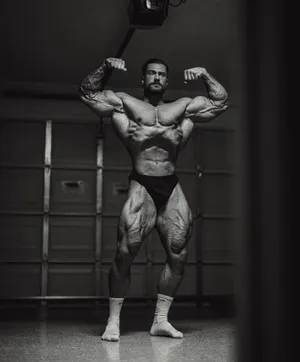 Muscular Man Posingwith Dumbbell Wallpaper