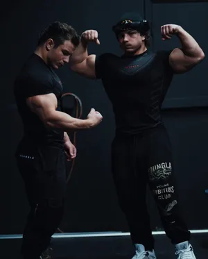 Muscular Twins Flexing Biceps.jpg Wallpaper