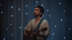 Musician Performing Livewith Guitar Wallpaper