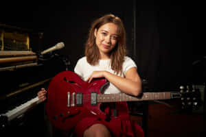 Musicianwith Red Guitarin Studio Wallpaper