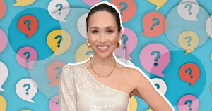 Myleene Klass Smiling Against Question Mark Backdrop Wallpaper