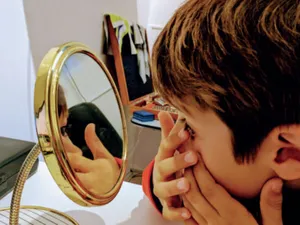 Myopic Kid Checking Its Eyes Wallpaper