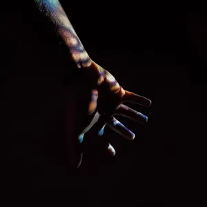 Mysterious Dark Hand Reaching Out From The Shadows Wallpaper