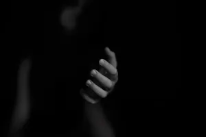 Mysterious Dark Hand Reaching Out In Darkness Wallpaper