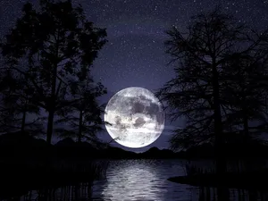 Mysterious Dark Moon Illuminating The Night Sky Wallpaper