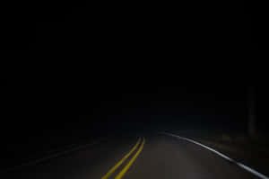 Mysterious Dark Road At Night Wallpaper