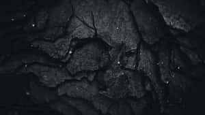 Mysterious Dark Rock Formation In A Lonely Landscape Wallpaper