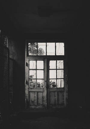 Mysterious Entrance - Weathered Door In An Old, Spooky Building Wallpaper