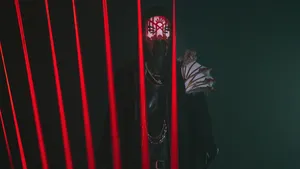 Mysterious_ Figure_ Behind_ Red_ Lights.jpg Wallpaper