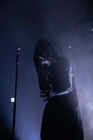 Mysterious_ Figure_in_ Smoke_on_ Stage.jpg Wallpaper