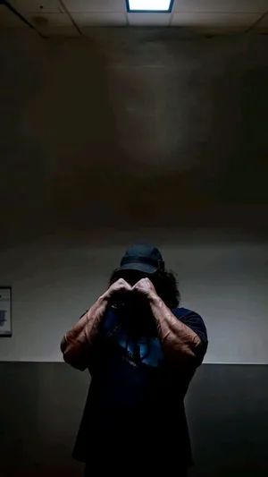 Mysterious Figure Under Light Wallpaper