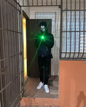 Mysterious_ Figure_with_ Green_ Laser Wallpaper
