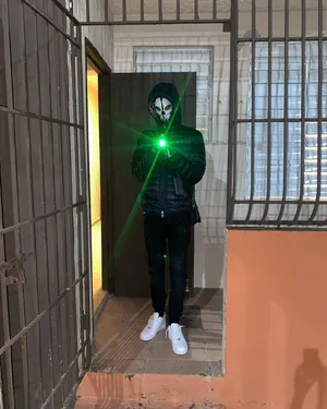 Mysterious_ Figure_with_ Green_ Laser Wallpaper