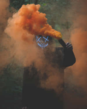 Mysterious_ Figure_ With_ Orange_ Smoke Wallpaper