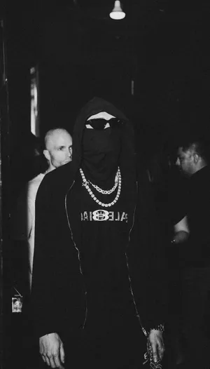 Mysterious Figurein Hoodieand Chain Necklace Wallpaper