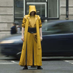 Mysterious Figurein Yellow Robe Wallpaper