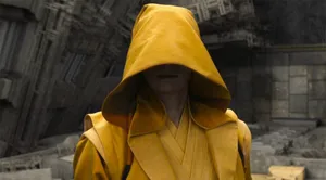 Mysterious Figurein Yellow Robe Wallpaper