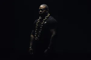 Mysterious Figurewith Gold Chain Wallpaper