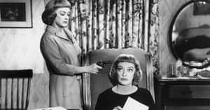 Mysterious Film Noir Detective In Rainy City Wallpaper