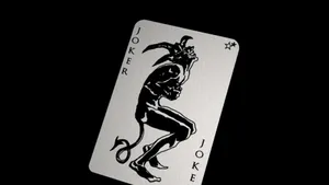 Mysterious Joker Card On A Dark Background Wallpaper