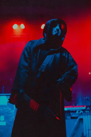 Mysterious_ Musician_ Under_ Red_ Lights.jpg Wallpaper