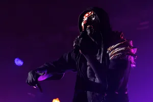 Mystic_ Performer_ Under_ Purple_ Lights Wallpaper