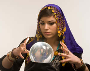 Mystical Fortune Teller Gazing At Crystal Ball Wallpaper