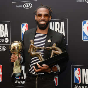 N B A Awards Winner Holding Trophies Wallpaper