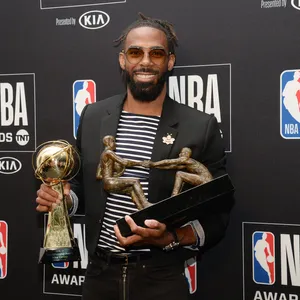 N B A Awards Winner Holding Trophies Wallpaper