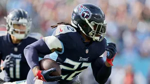 N F L Player In Action During Game Wallpaper