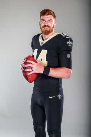 N F L Quarterback Posing With Football Wallpaper