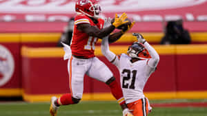 N F L Receiver Catch Attempt Against Defender Wallpaper