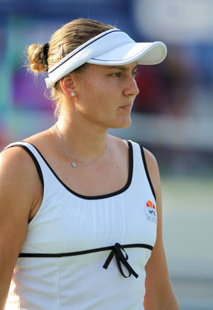 Nadia Petrova Gracefully Poses In A White Visor And Dress Wallpaper