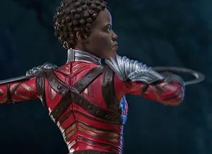 Nakia Radiates Power And Elegance In A Vibrant Setting. Wallpaper