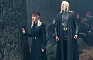 Narcissaand Lucius Malfoy Standingin Forest Wallpaper