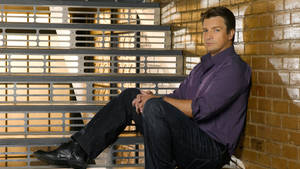 Nathan Fillion Sitting Floor Wallpaper