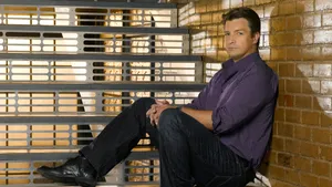 Nathan Fillion Sitting Floor Wallpaper