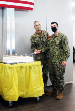 Navy Personnel Celebratingwith Cake Wallpaper