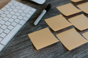 Neat And Organized Sticky Notes Over Desk Wallpaper