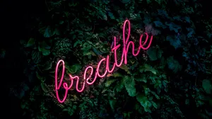 Neon_ Breathe_ Sign_ Amidst_ Greenery Wallpaper
