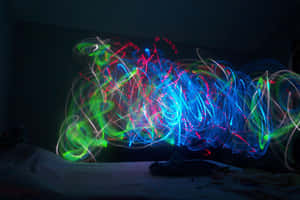 Neon Light Trailsin Dark Room Wallpaper