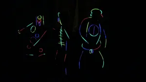 Neon Lit Dancers In Darkness Wallpaper