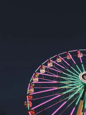 Neon Lit Ferris Wheelat Night Wallpaper